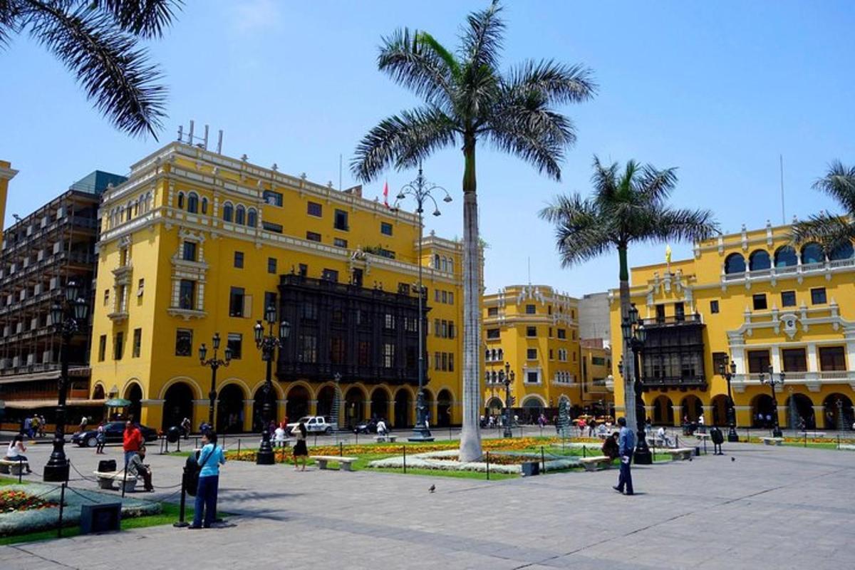 a yellow building with palm trees in front of it