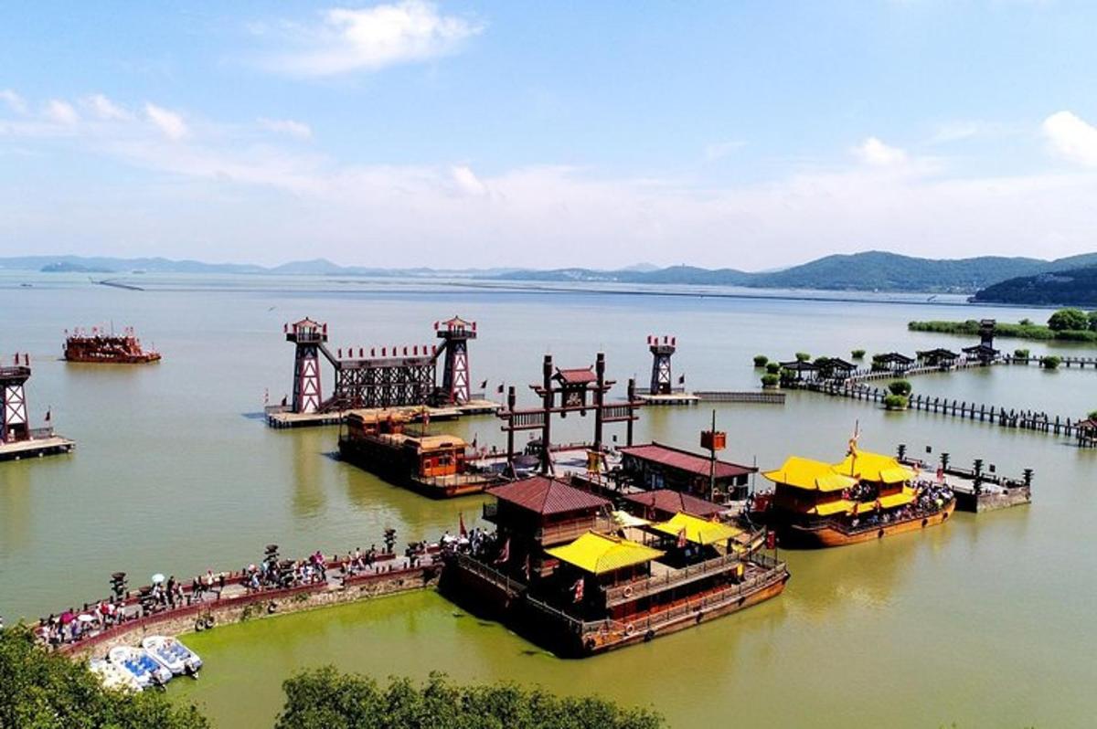 a group of boats docked at a pier on a lake