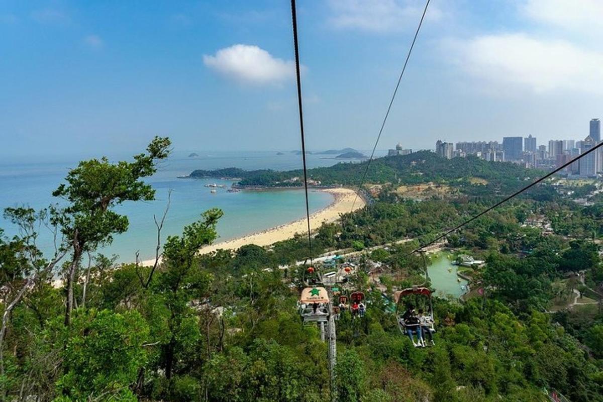 a group of people riding a gondola over a beach