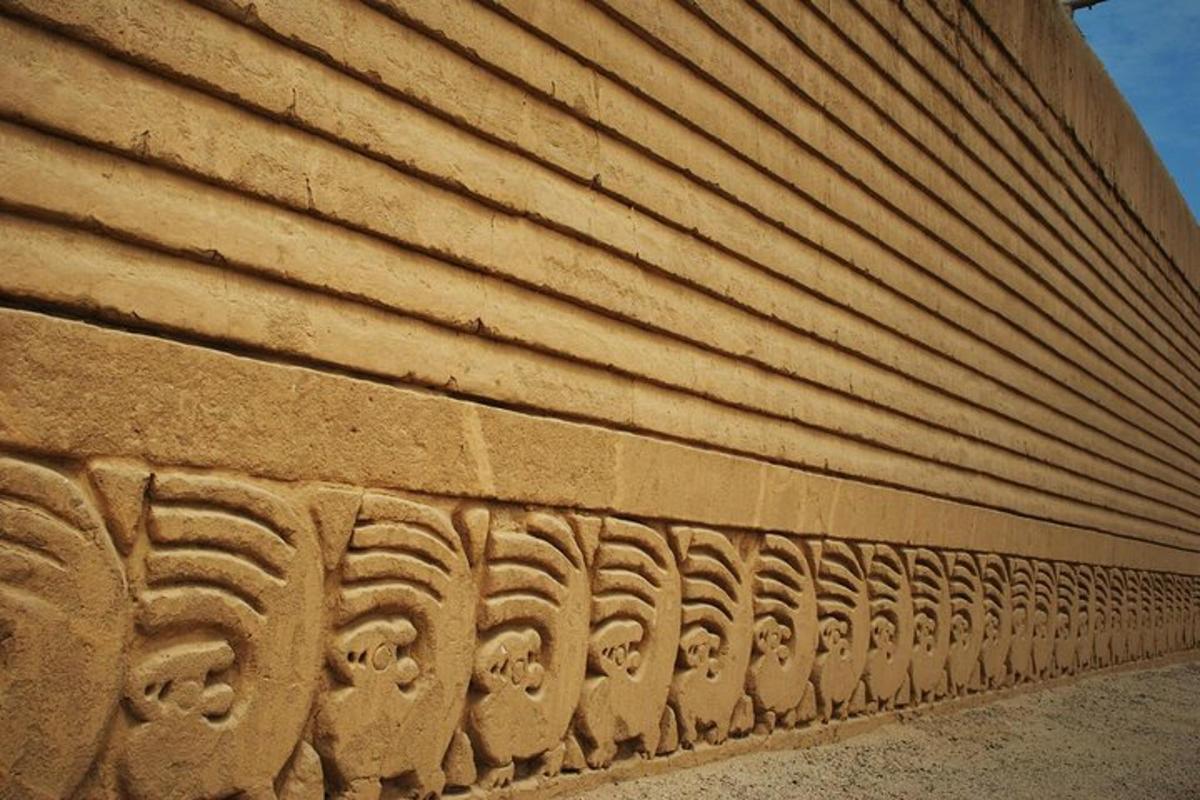 a stone wall with patterns on the side of a building