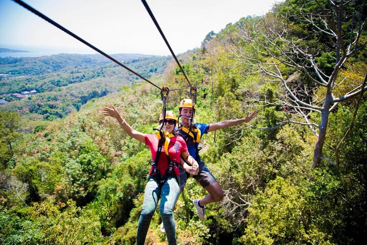 a man and woman on a zip line in the mountains