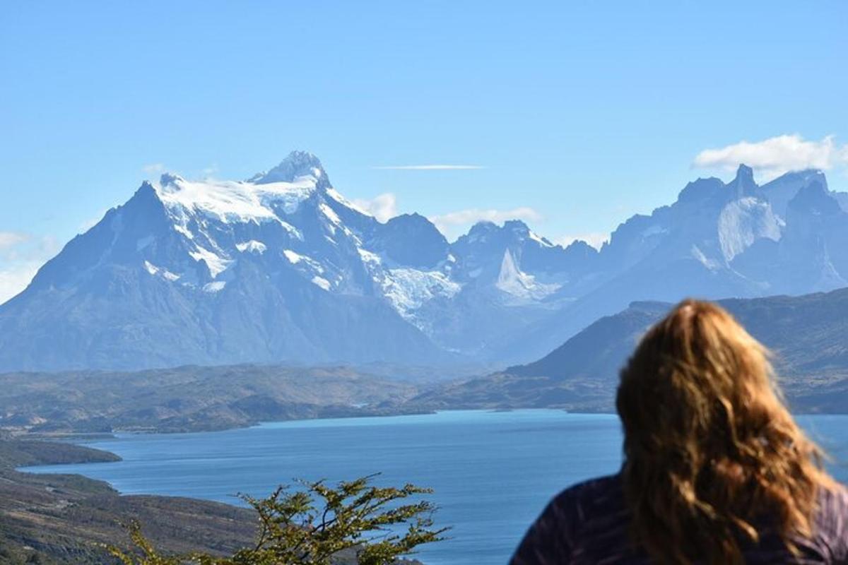 a woman looking out at a mountain range