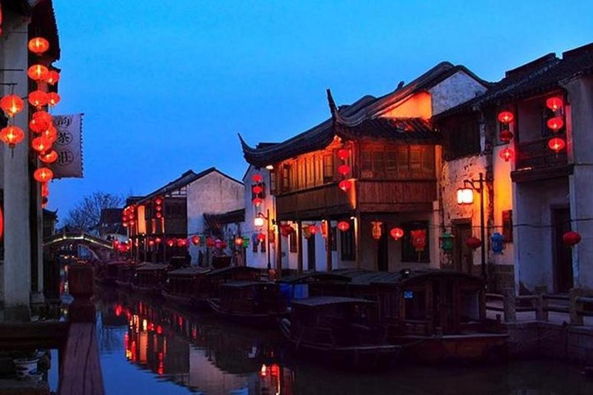 an asian city at night with red lights on buildings
