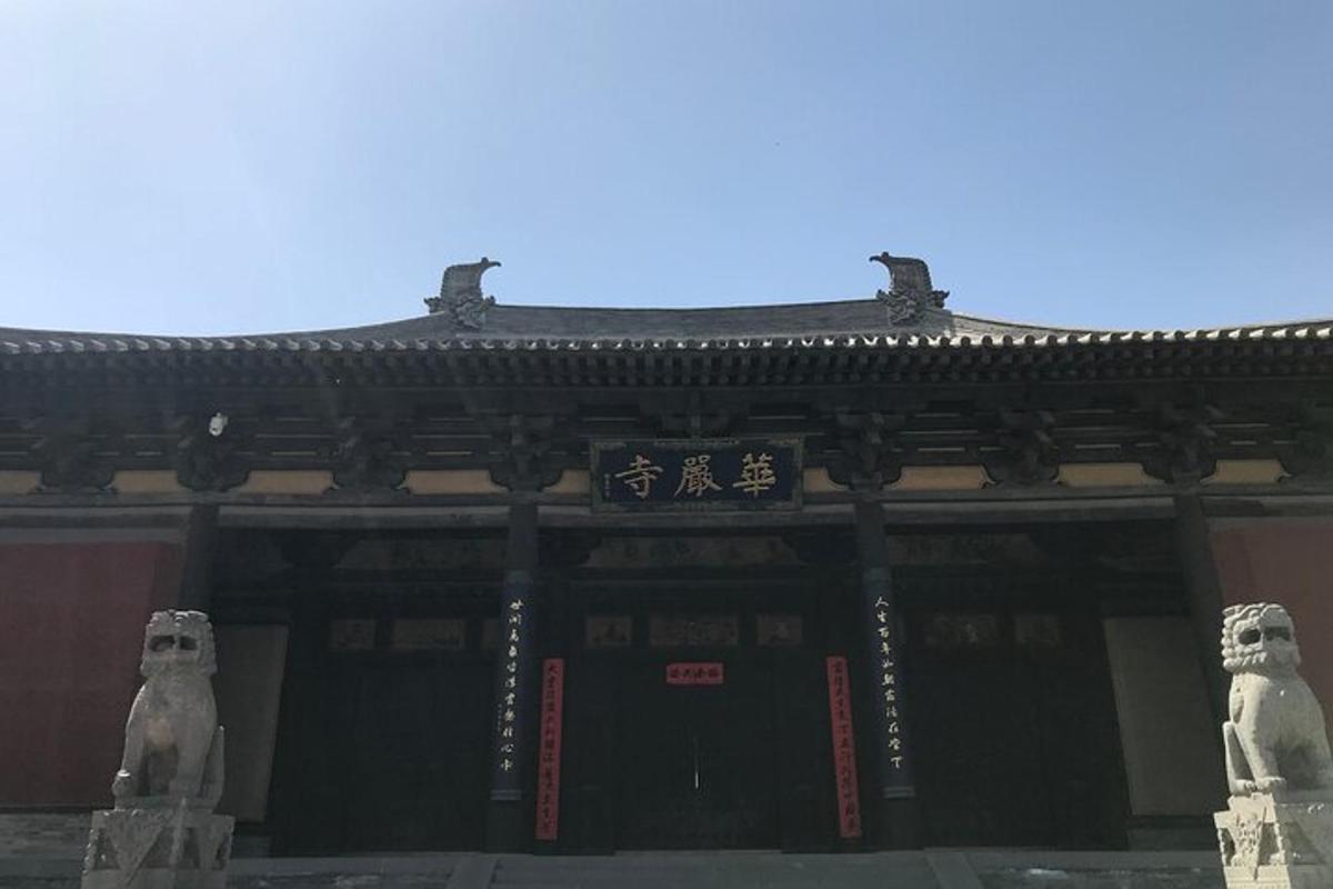 two statues of bears in front of a building