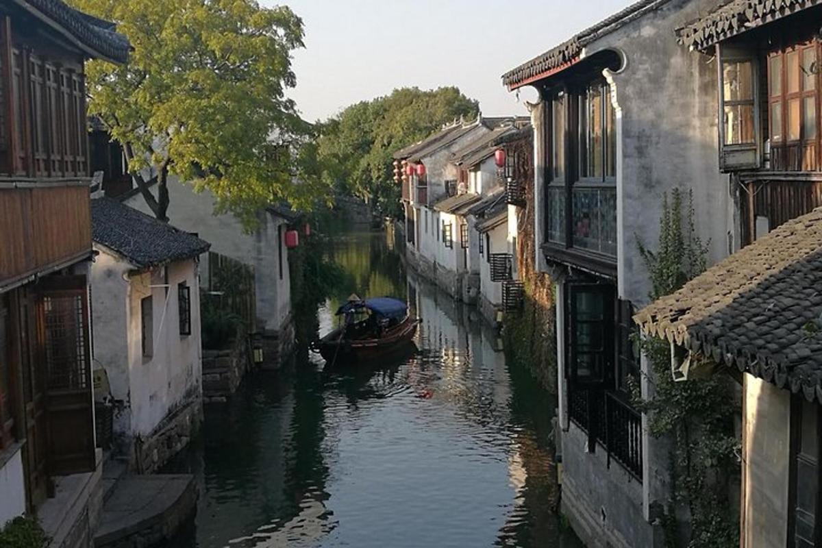 a boat in a canal between two buildings