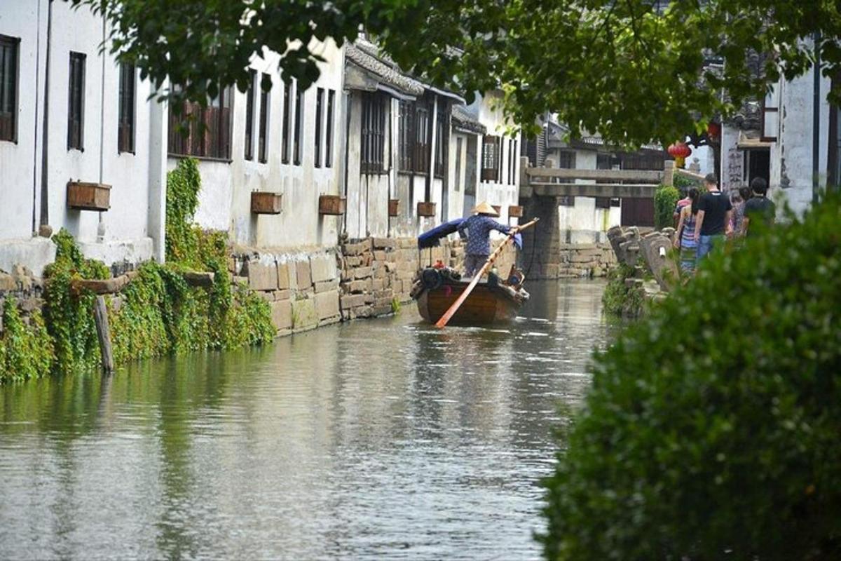 a man is rowing a boat down a river