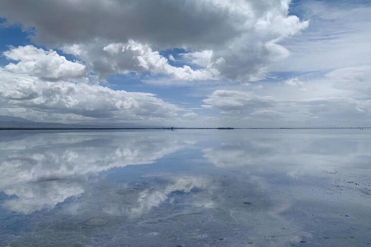 a large body of water with clouds in the sky