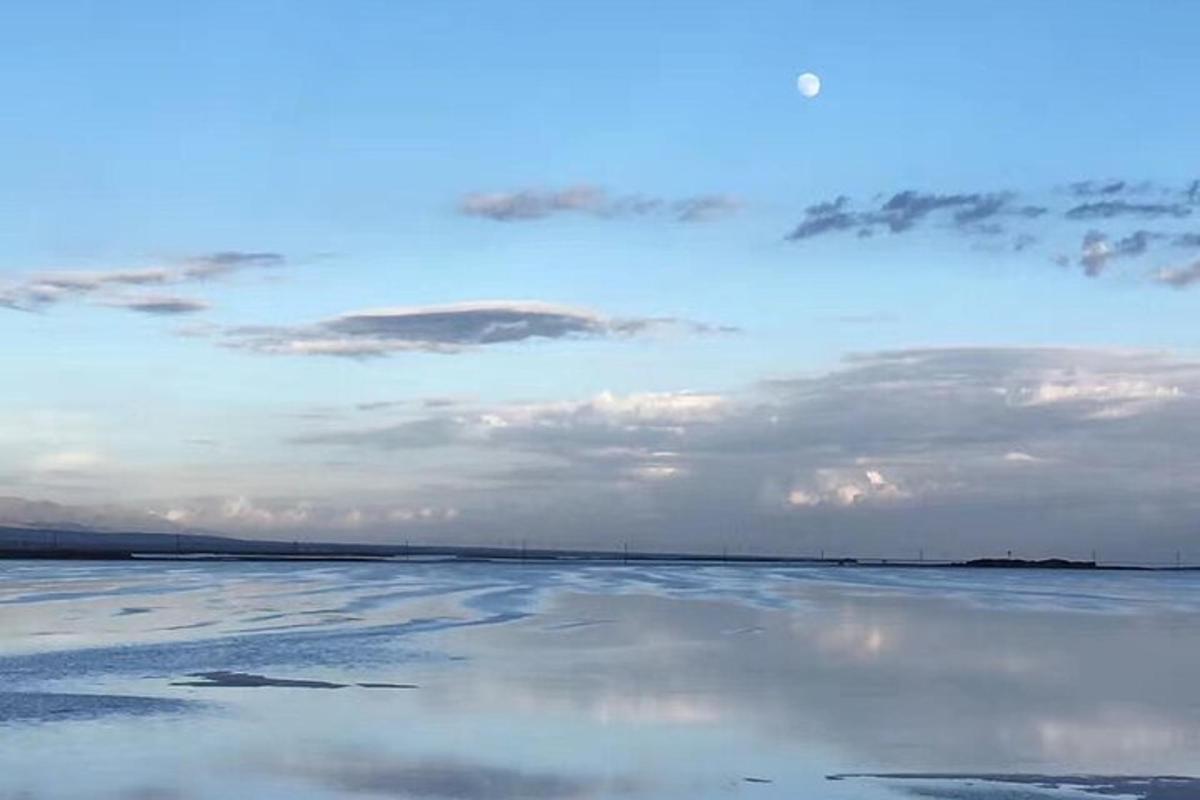a large body of water with a cloudy sky