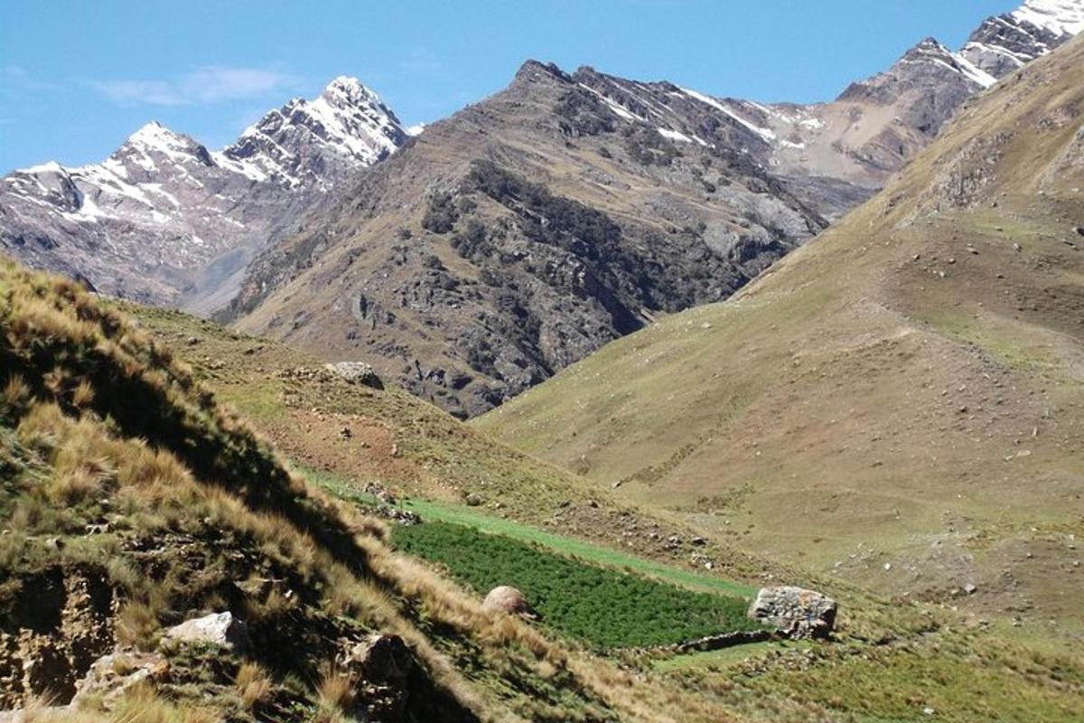 a view of a mountain with snow capped mountains