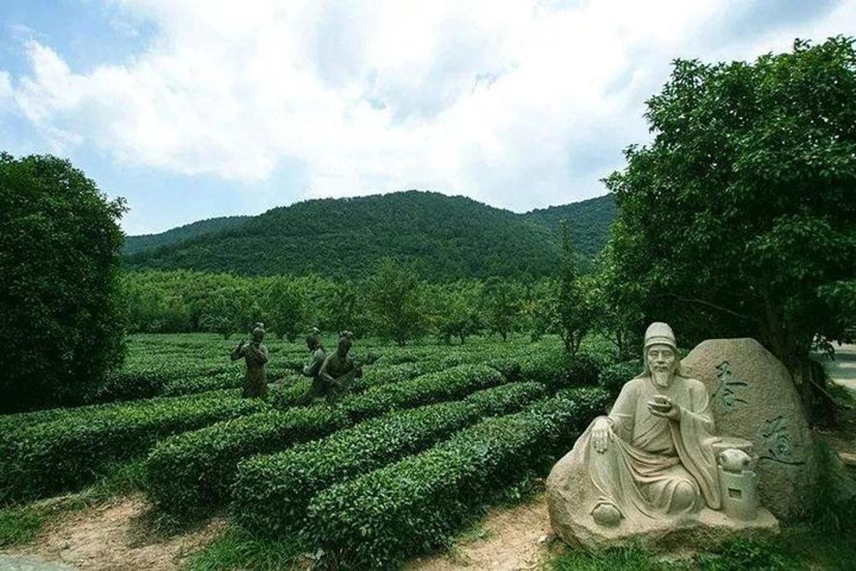 a statue of a woman in a field of crops