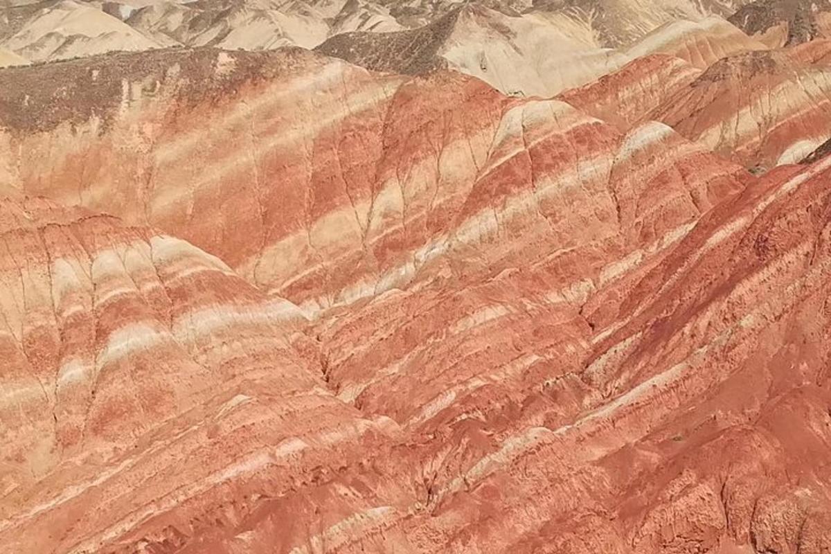 a painting of a desert with mountains in the background