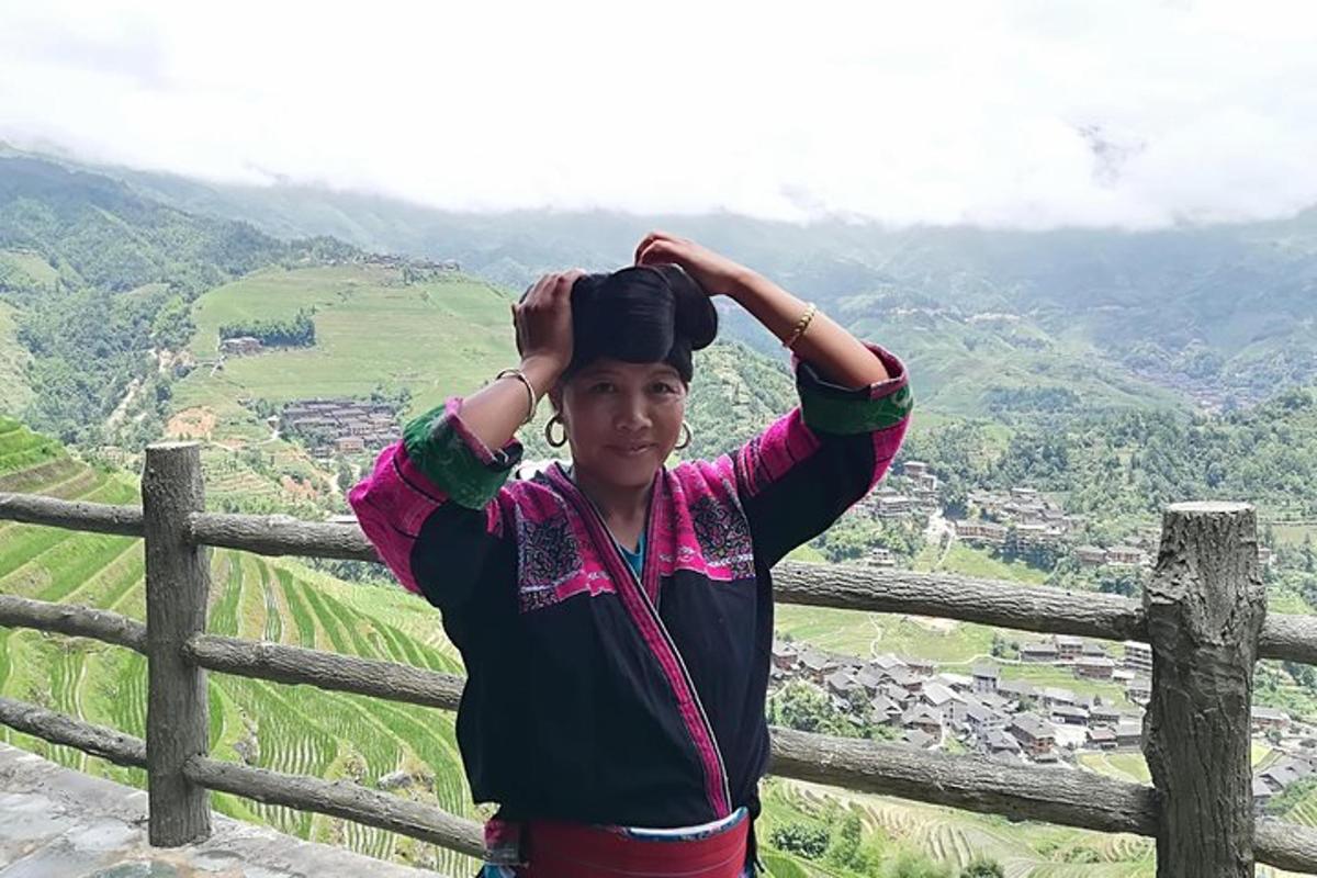 a woman standing on top of a mountain