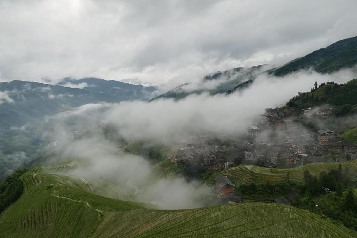 a view of a town in the clouds on a mountain