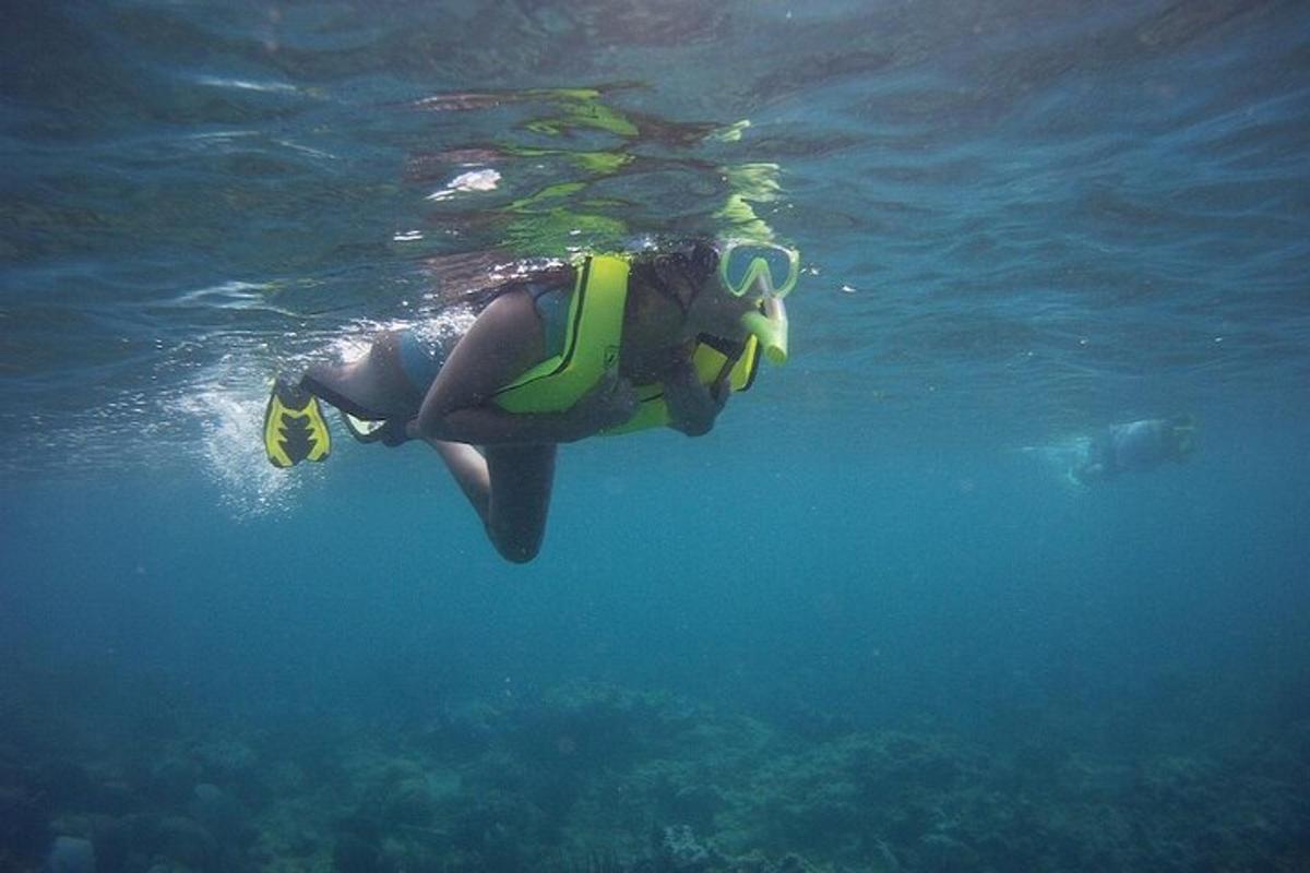 a person in a life vest swimming in the water