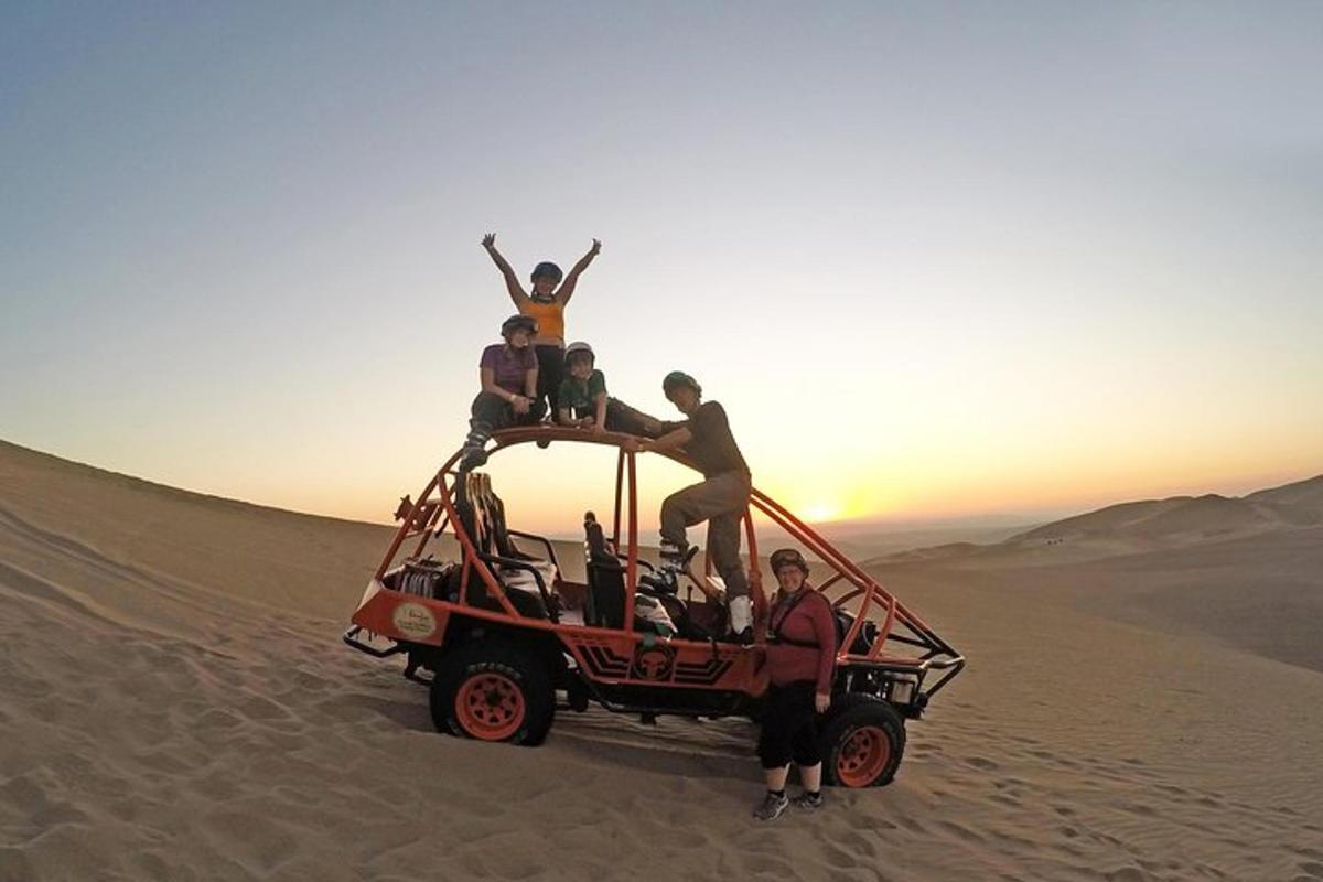 a group of people standing on top of a jeep in the desert