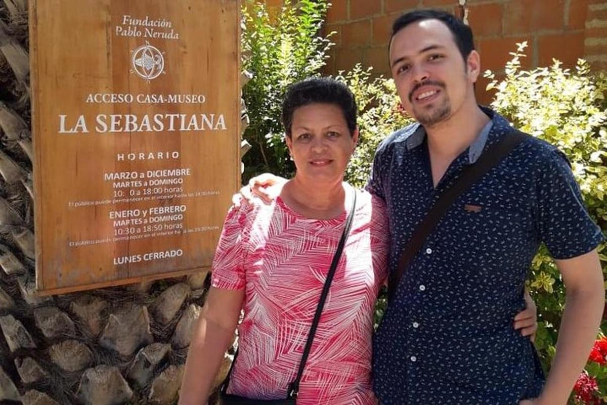 a man and a woman standing in front of a sign
