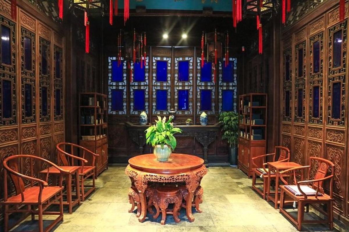 a room with a table and chairs and a window