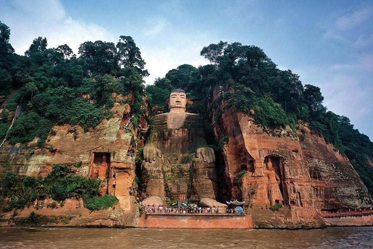 a large statue on a mountain in the water