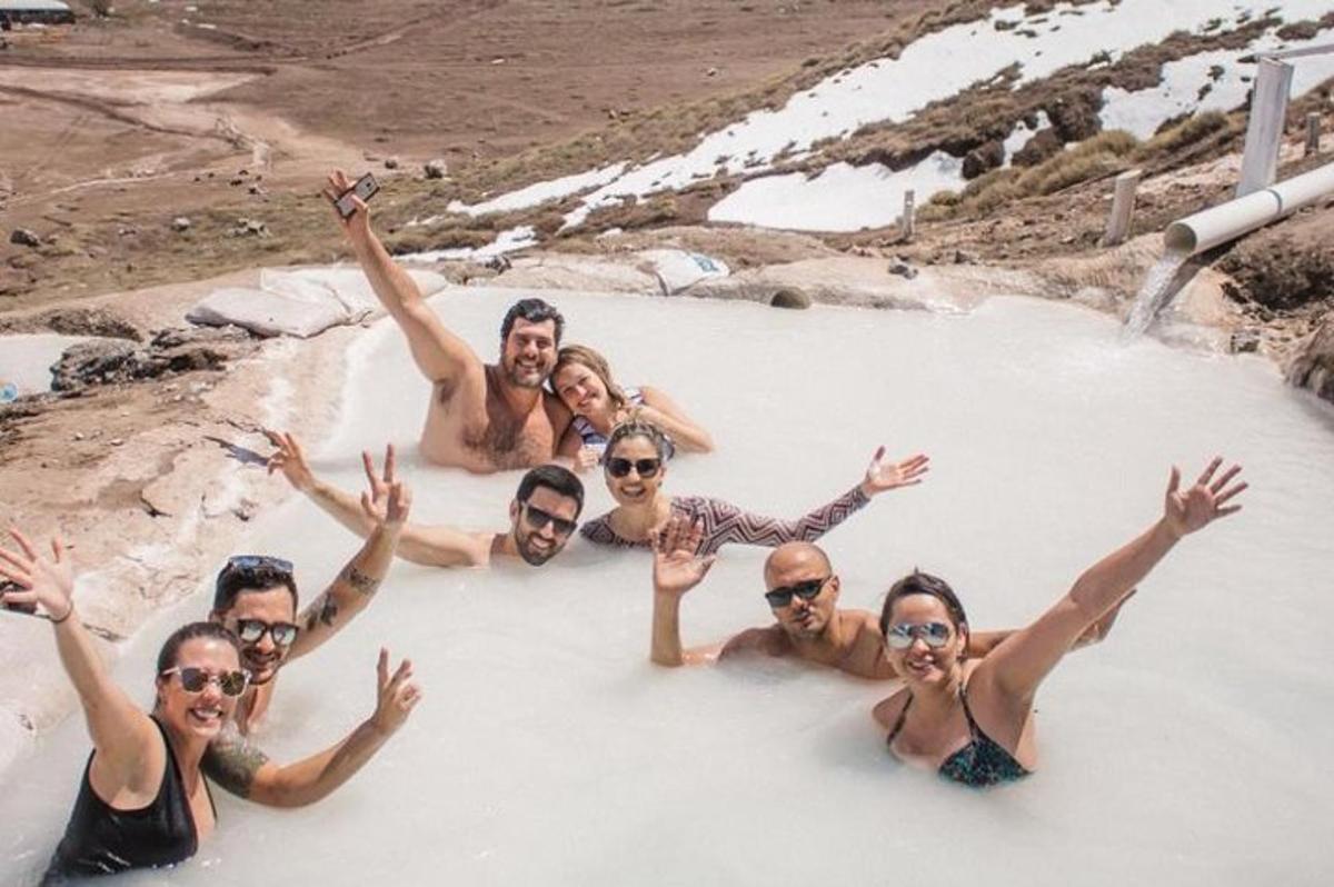 a group of people swimming in a hot tub