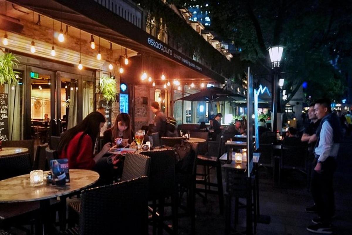 a group of people sitting at a restaurant at night