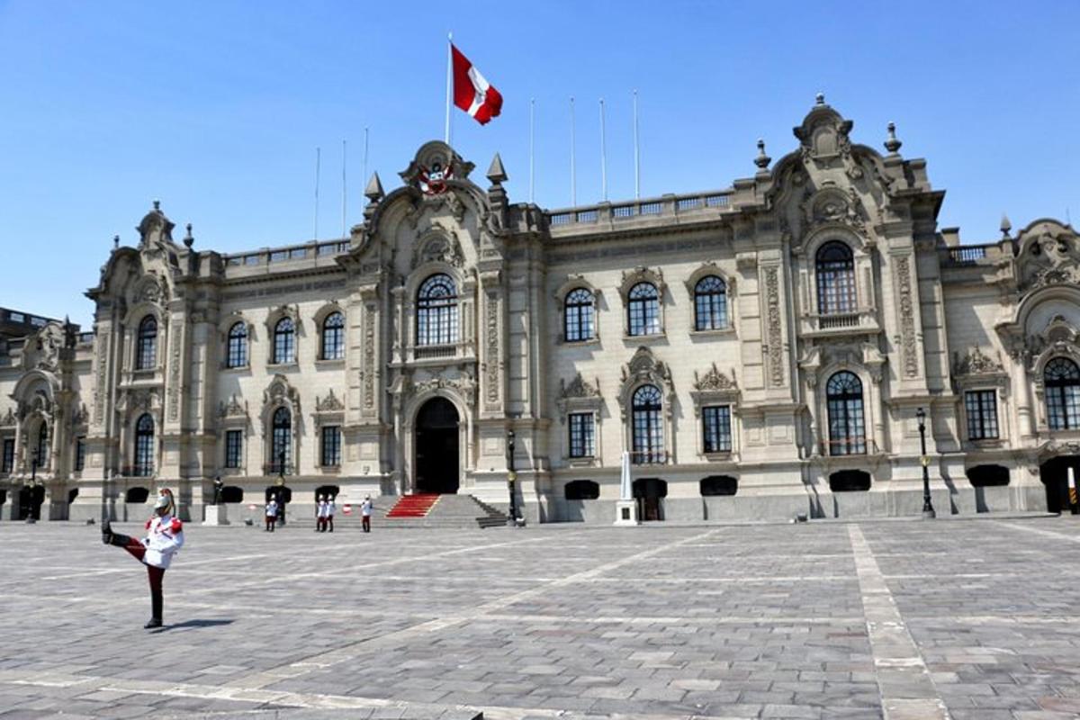 a woman standing in front of a large building with a flag