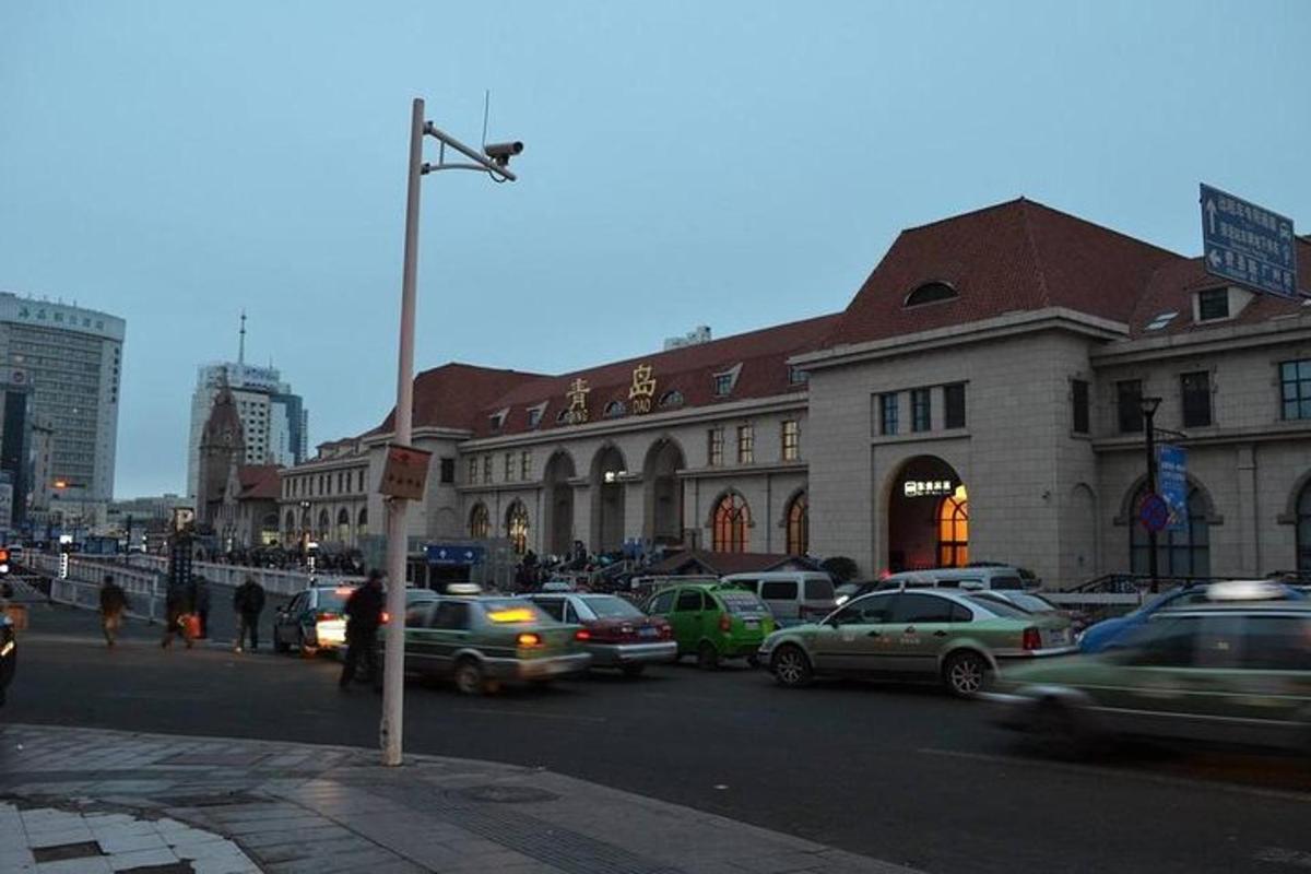 a busy city street with cars parked in front of a building