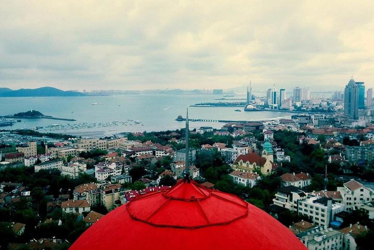 a red umbrella with a view of a city