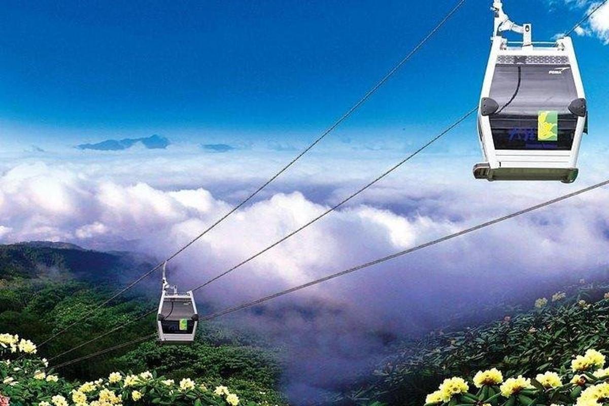 two ski lifts in the sky above the clouds
