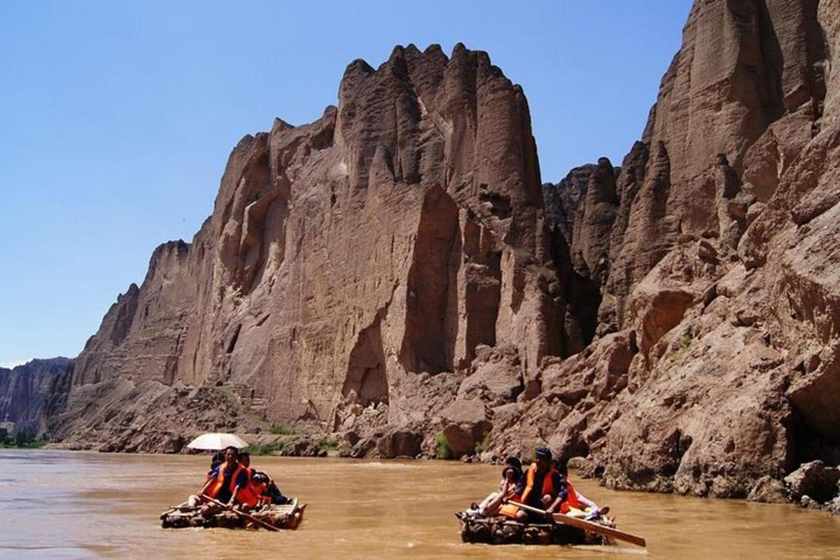 a group of people riding down a river on canoes