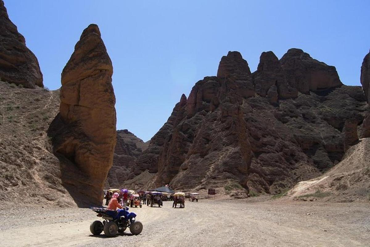 a group of people on a dirt road in a mountain