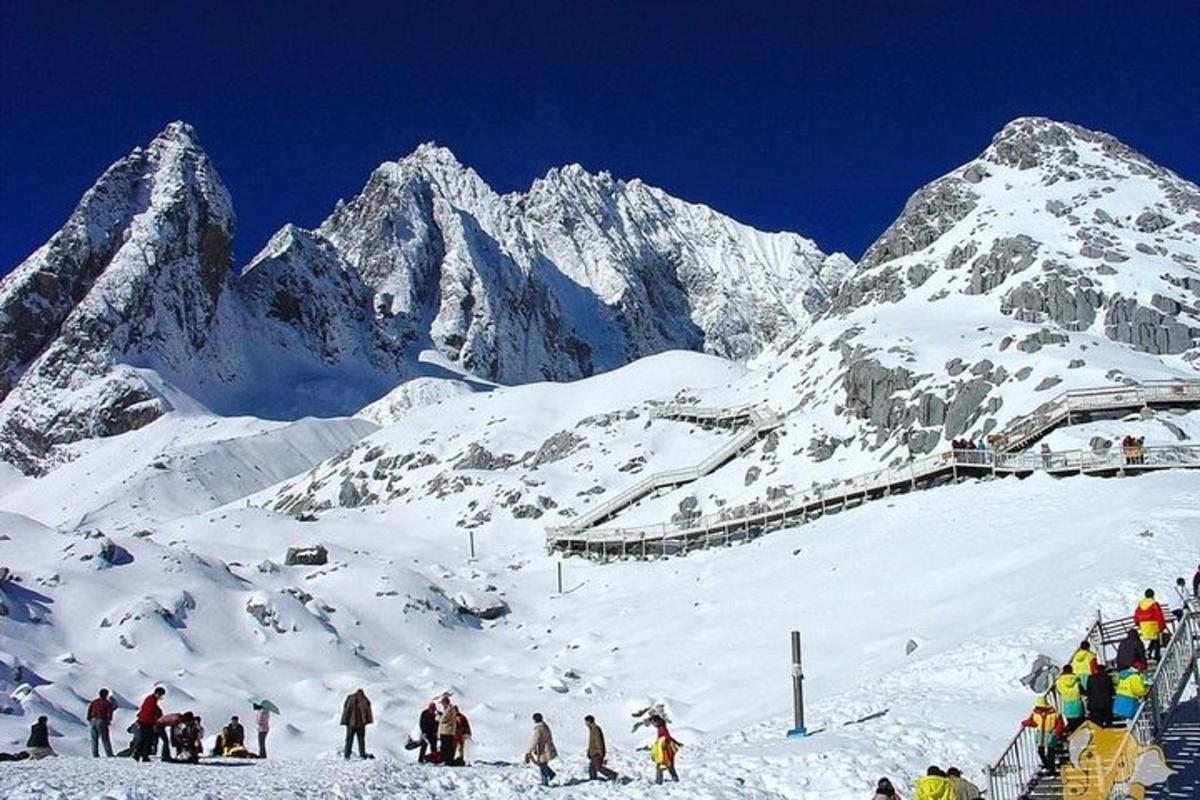 a group of people skiing on a snow covered mountain