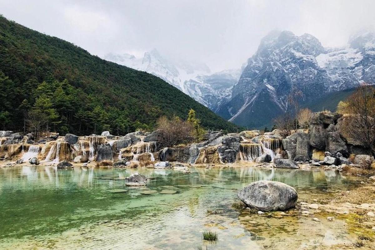 a pool of water with mountains in the background