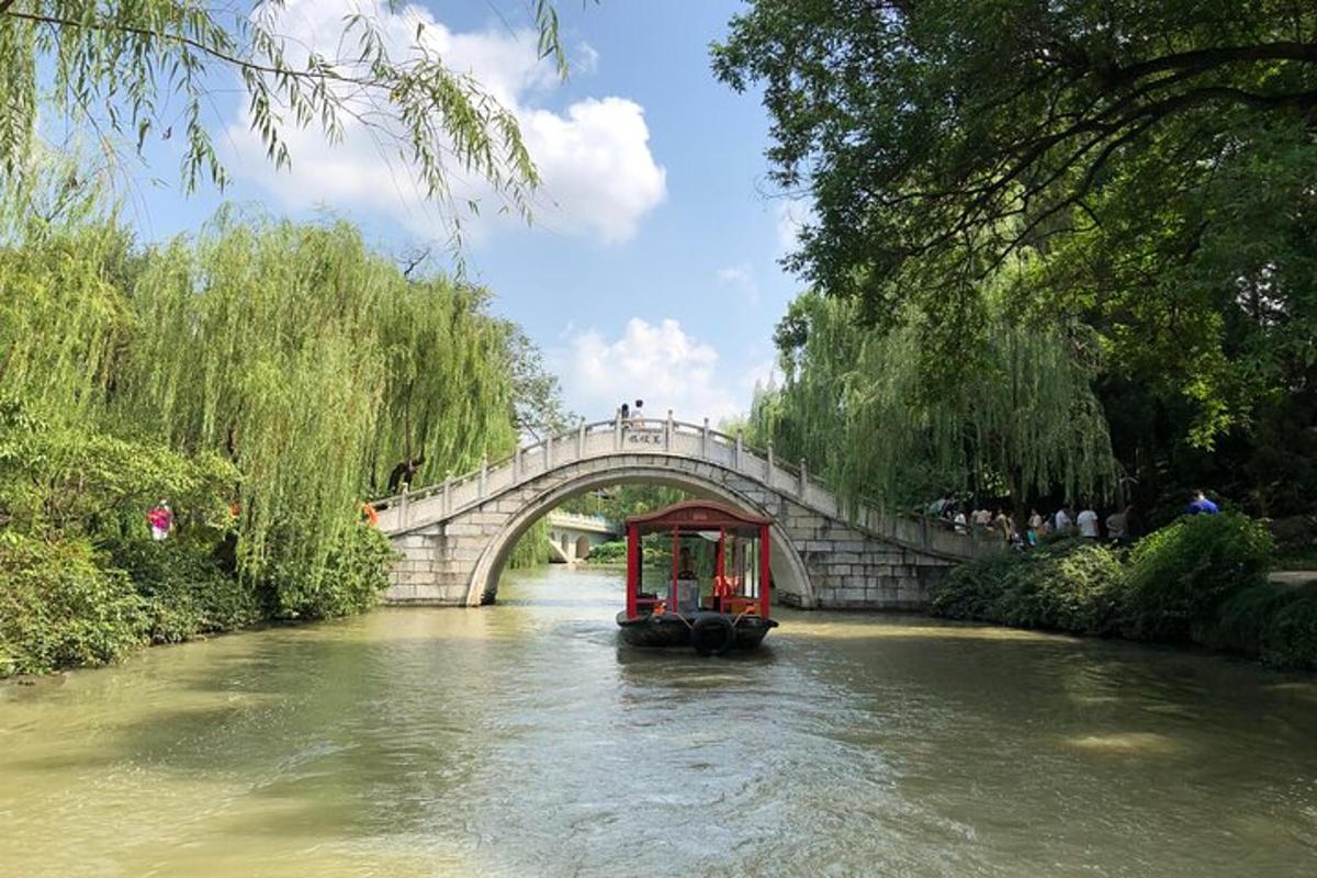 a boat in a river with a bridge