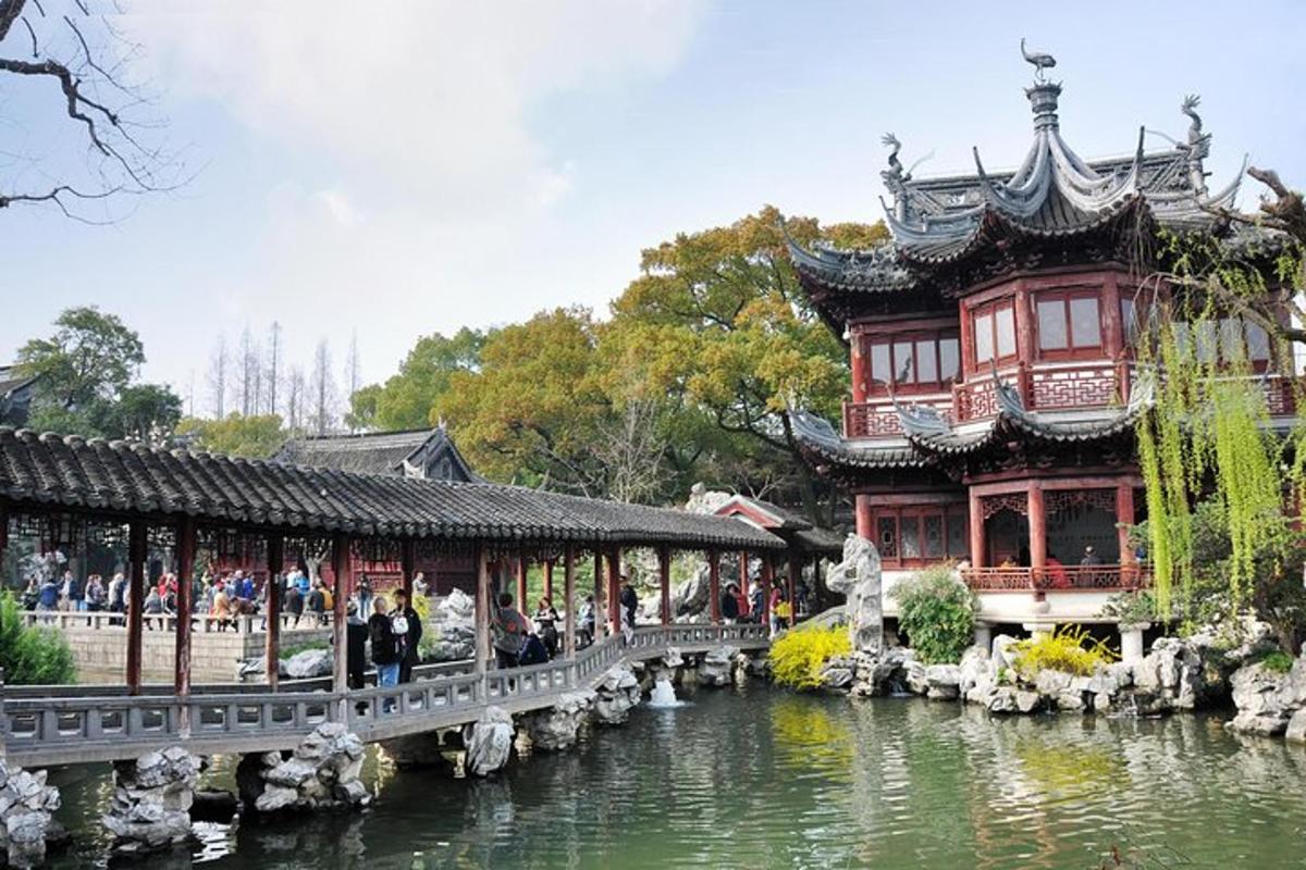 a large building with a bridge over a pond