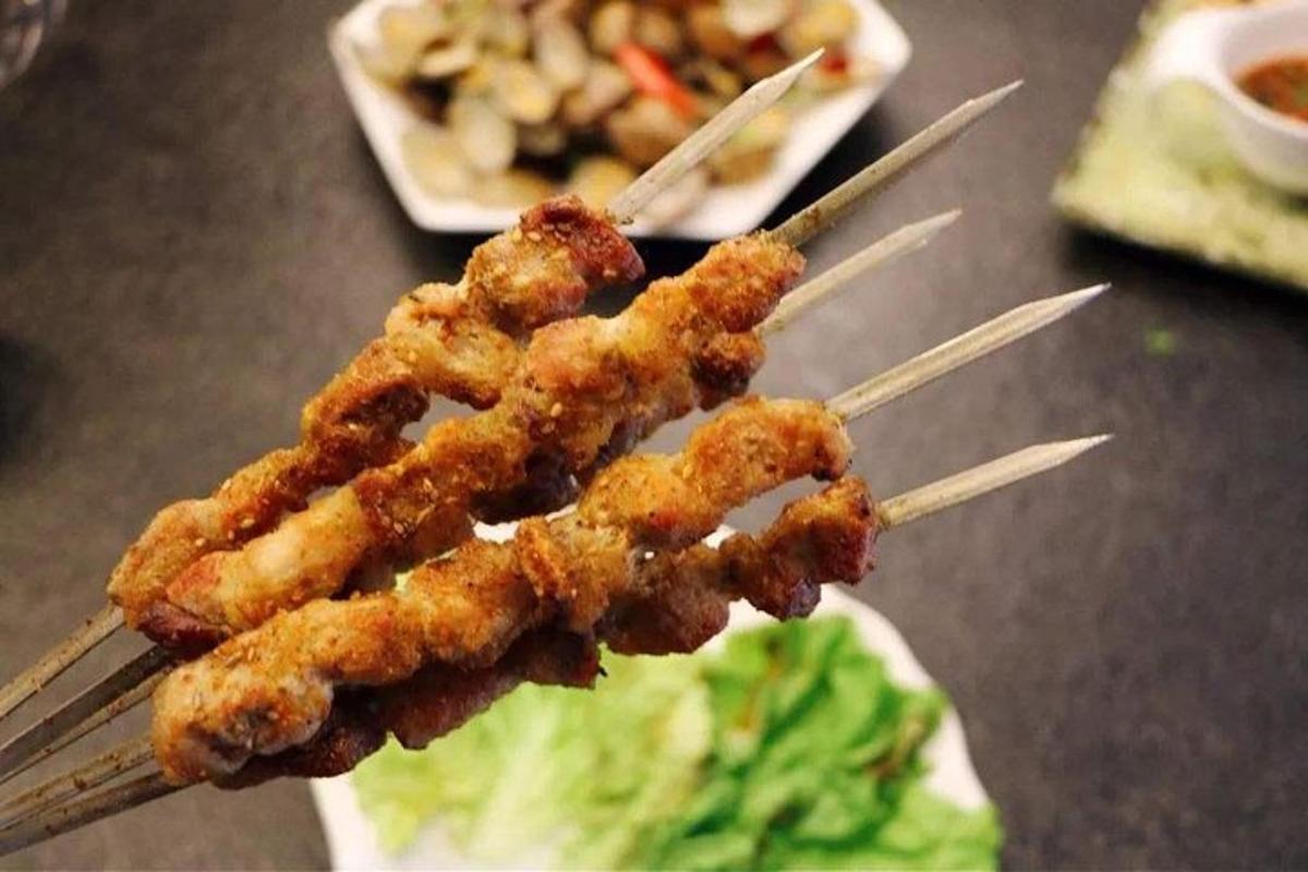a group of food on chop sticks with lettuce