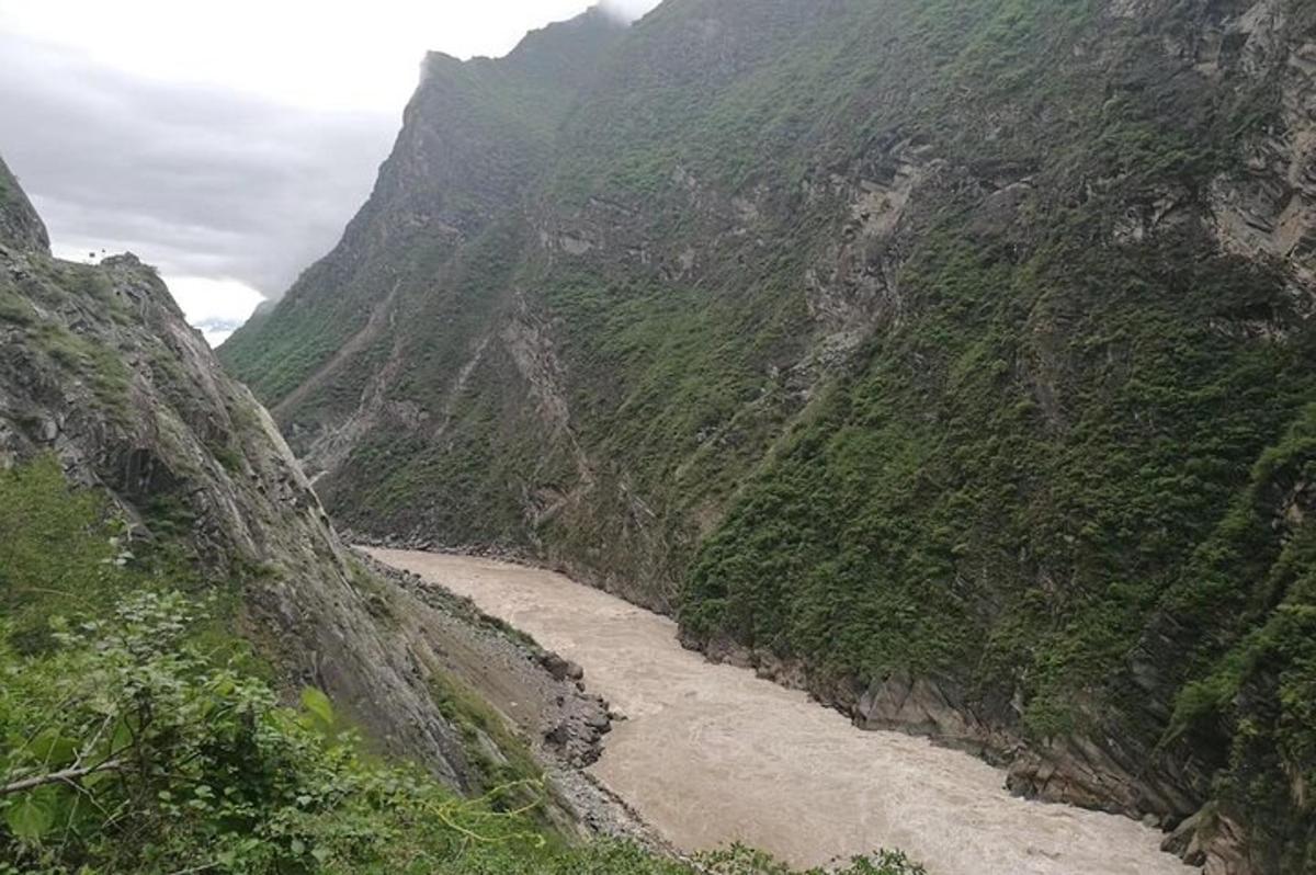 a canyon with a river in the middle of a mountain