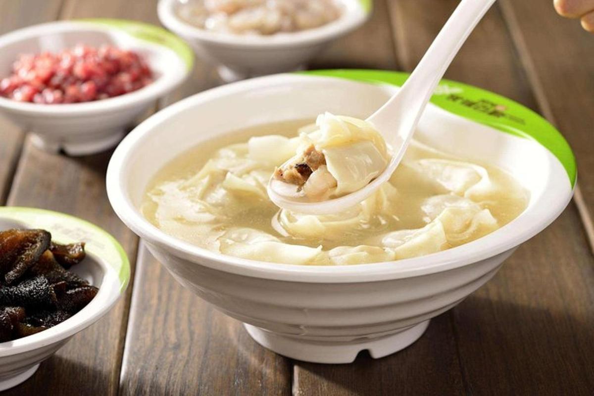 a bowl of soup with a spoon in it on a table