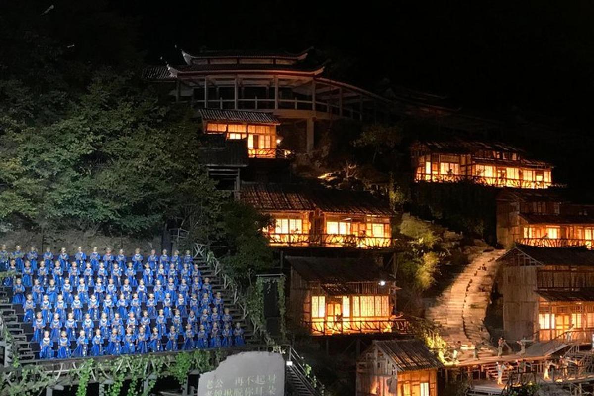 a building with blue chairs in front of it at night