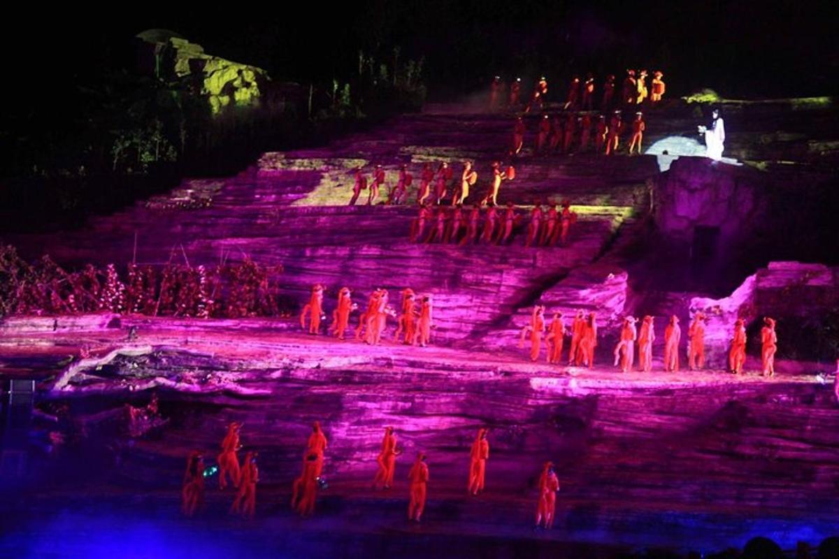 a group of people standing on a stage at night