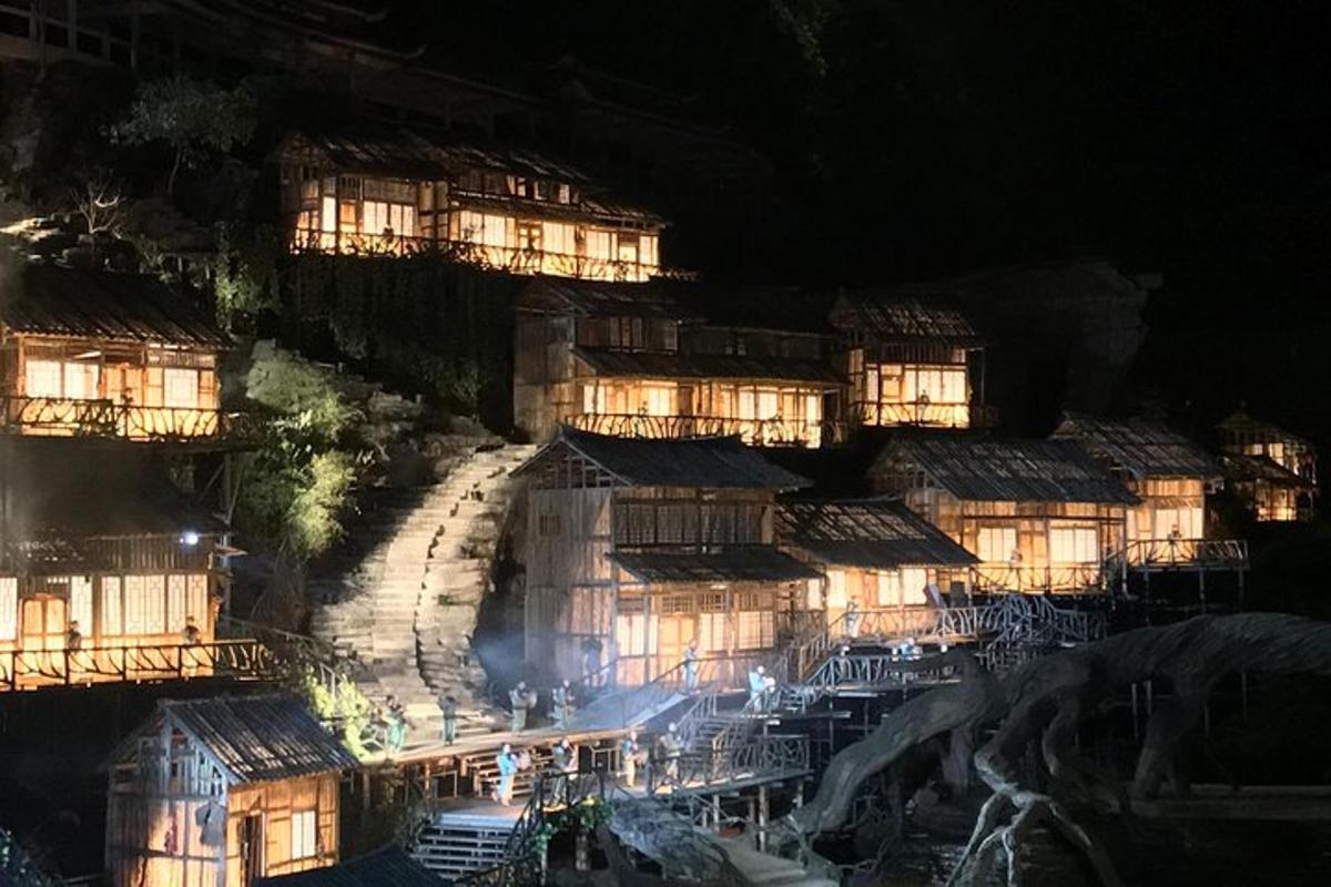 a group of buildings on a mountain at night