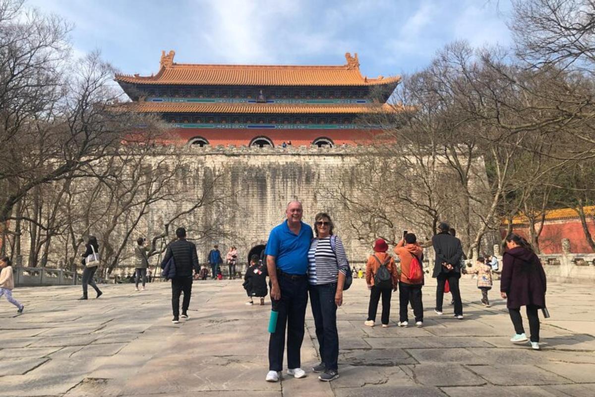 a man and a woman standing in front of a building