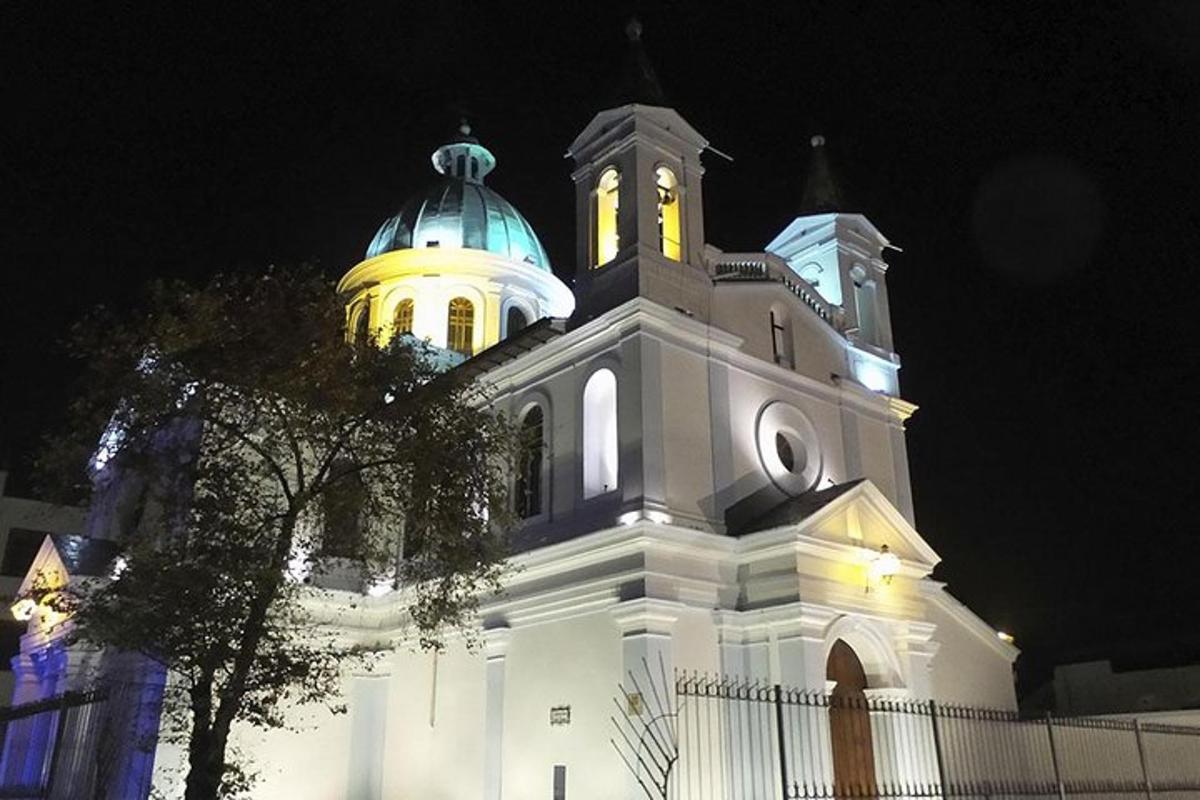 a white building with a clock tower at night