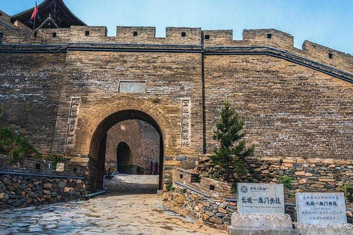 a large brick wall with an archway in a building