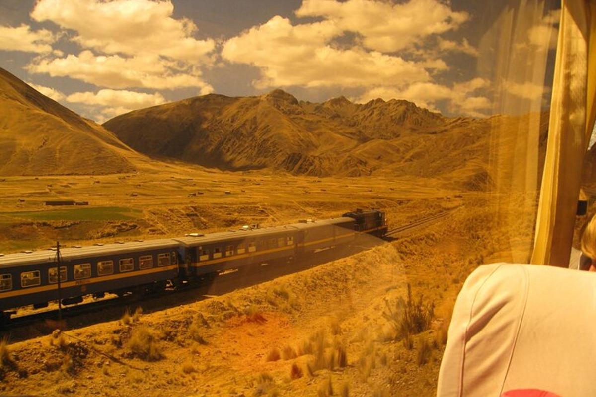 a train is traveling through a desert with mountains