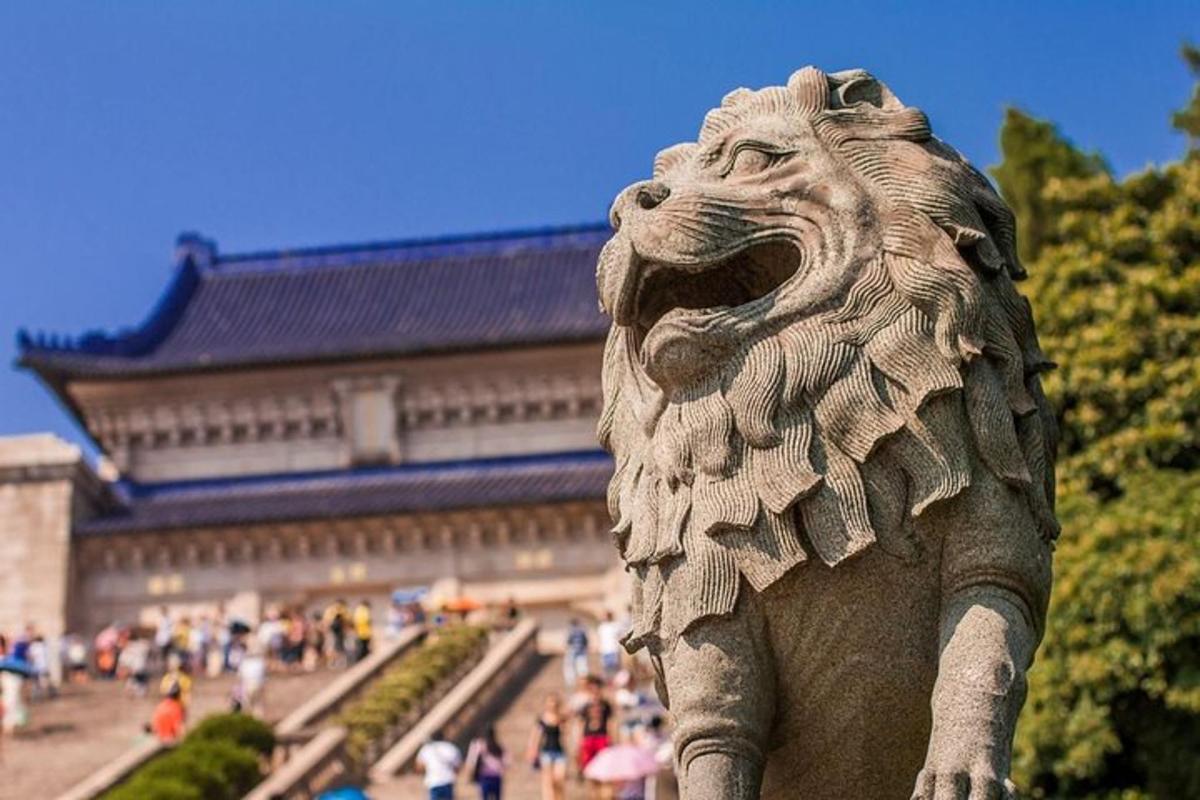 a stone lion statue in front of a building
