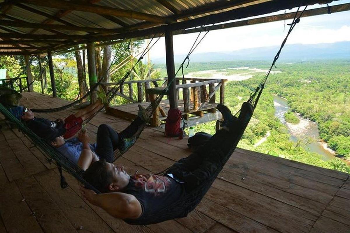 a group of people laying in hammocks on a deck