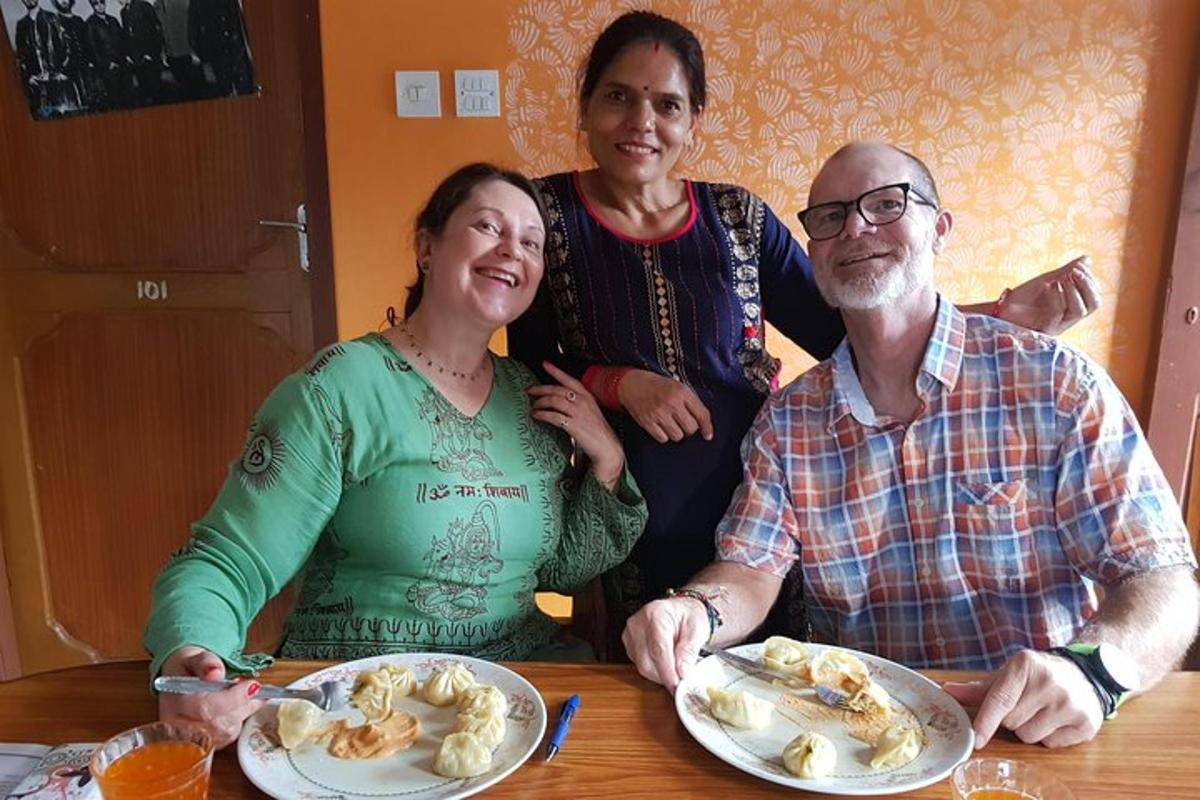 three people sitting at a table with plates of food