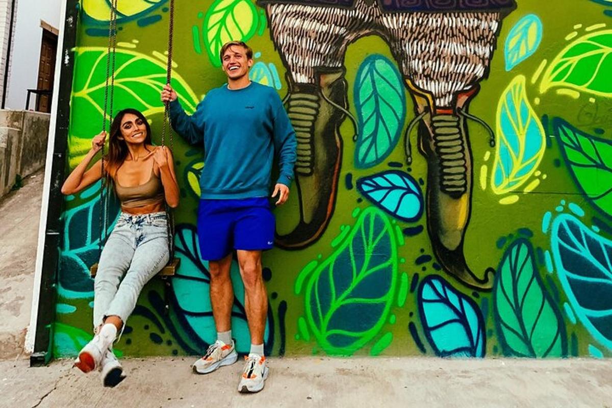 a man and a woman standing in front of a wall