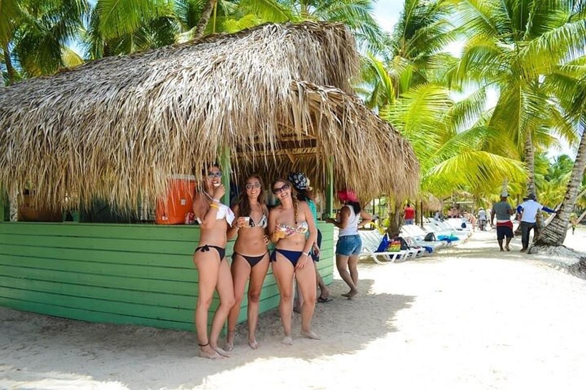 three women in bikinis standing on a beach