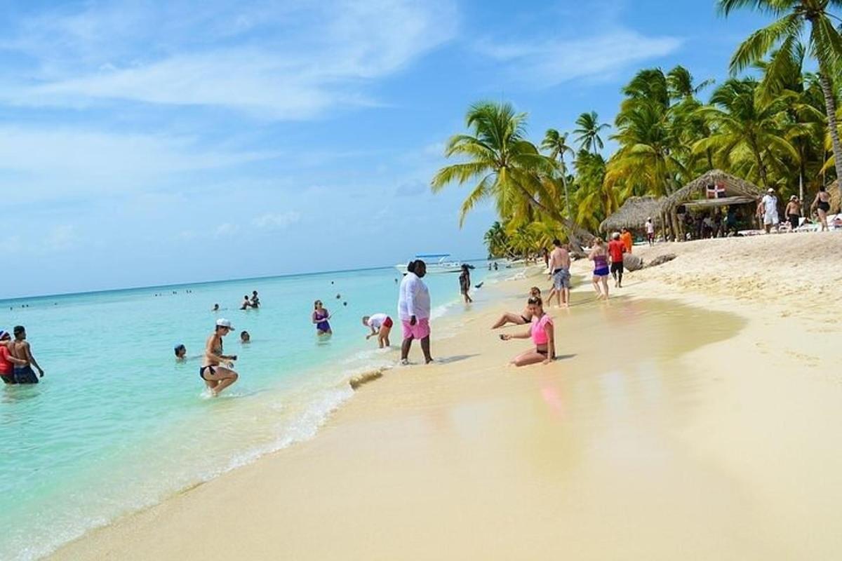 a group of people playing in the water on a beach